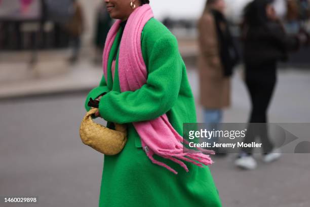 Fashion week guest seen wearing a yellow Mini Jodie by Bottega Veneta, a green long coat by The Frankie Shop and pink scarf before the Georges...