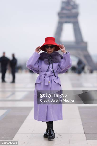 Helene in Paris seen wearing red hat, purple coat and black boots before Stephane Rolland show during Paris Fashion Week on January 25, 2023 in...