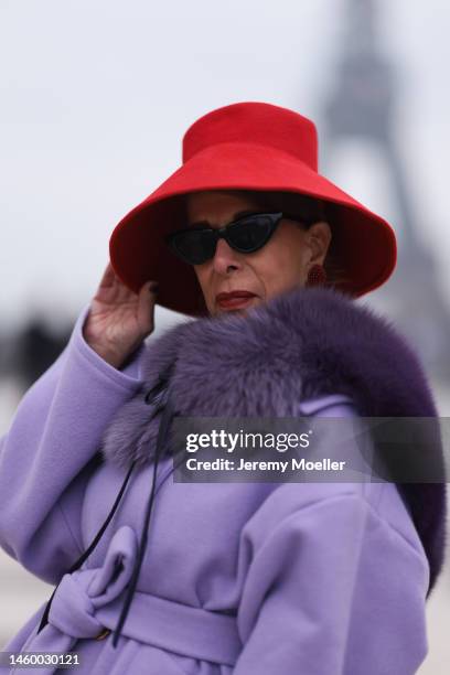 Helene in Paris seen wearing red hat, purple coat before Stephane Rolland show during Paris Fashion Week on January 25, 2023 in Paris, France.