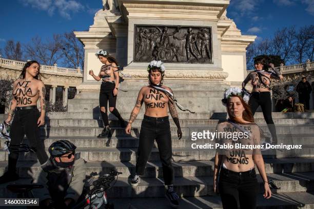 Activists with body paint reading 'Not one less' and 'for being a woman, not one less' protest against domestic violence held at El Retiro Park on...