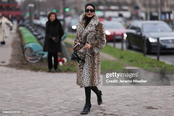 Ece Sukan seen wearing a leopard print long fur coat, black high boots, black sunglasses and a black handbag, outside the Chanel Show, during Paris...