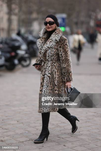 Ece Sukan seen wearing a leopard print long fur coat, black high boots, black sunglasses and a black handbag, outside the Chanel Show, during Paris...