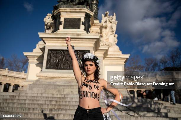 Activist with body paint reading 'Spain. Country of femicides' protest against domestic violence held at El Retiro Park on January 27, 2023 in...