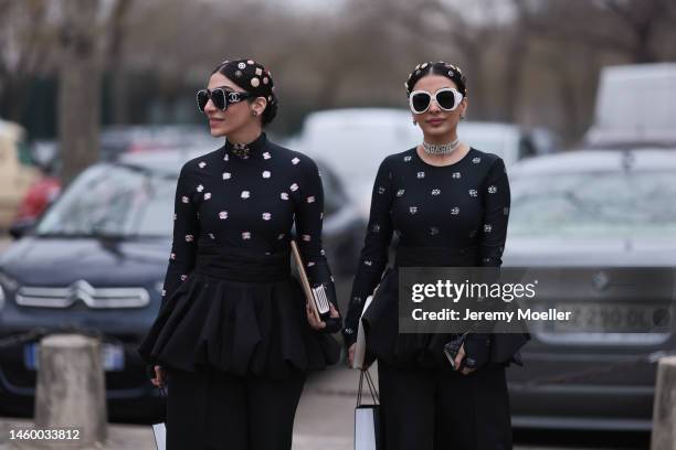 Fashion Week guests seen wearing a full Chanel black look, black shirt, skirt and silver Chanel hair details and accessories and Chanel sunglasses,...