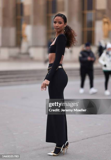 Flora Coquerel seen wearing a matching black look by Dan More with a black croptop and long tight skirt before the Georges Hobeika show on January...