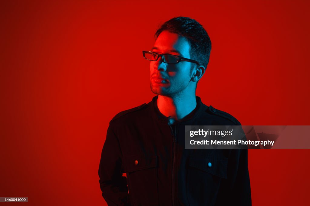 Handsome Man with Glasses on a Red Glowing Background