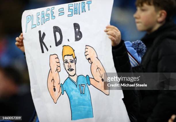 Fan of Manchester City, holds up a sign depicting Kevin De Bruyne of Manchester City which reads 'Please = Shirt, K.D.B', prior to the Emirates FA...