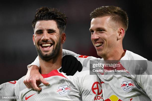 Dominik Szoboszlai of RB Leipzig celebrates after scoring the team's first goal with teammate Dani Olmo during the Bundesliga match between RB...