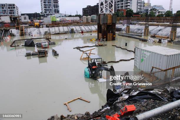 Digger is submerged in a flooded construction site in the Wynyard Quarter the morning after record heavy rain on January 28, 2023 in Auckland, New...