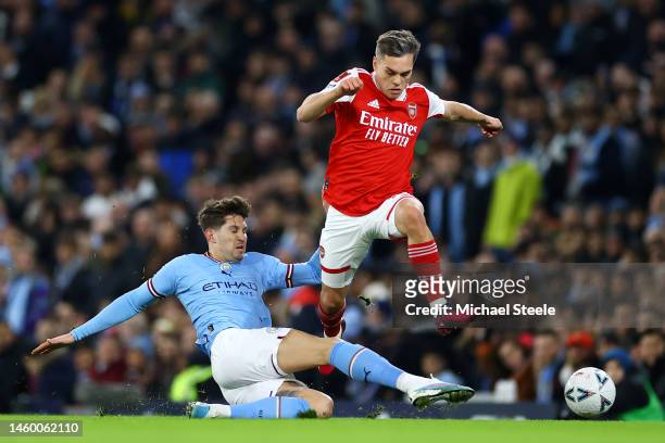 Leandro Trossard of Arsenal is tackled by John Stones of Manchester City during the Emirates FA Cup Fourth Round match between Manchester City and...