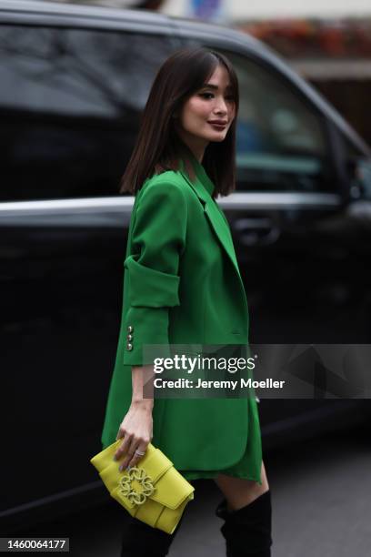 Heart Evangelista seen wearing a matching green look with an oversized blazer and blouse, a yellow leather bag and black boots before the Elie Saab...