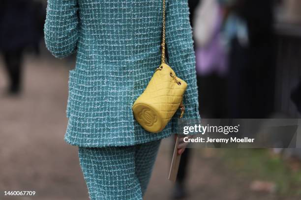 Fashion Week guest seen wearing a green Chanel suit, black shoes and a yellow Chanel handbag, outside the Chanel Show, during Paris Fashion Week's...