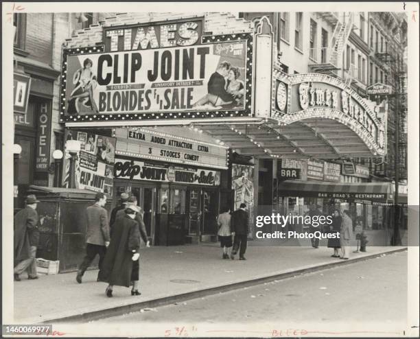 View of pedestrians under the marquee for the Times Theatre , New York, New York, 1930s. The marquee advertises a double bill of 'Clip Joint' and...