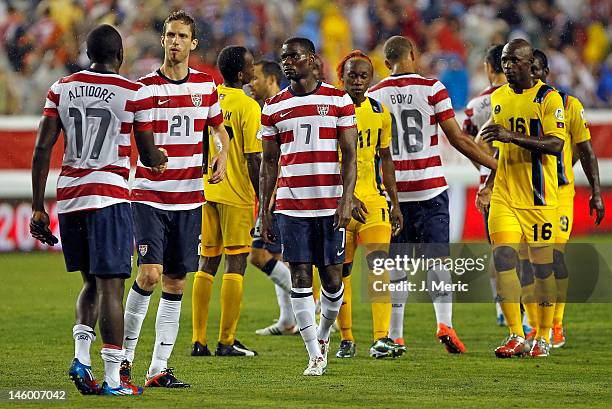 Forward Jozy Altidore, defender Clarence Goodson and Maurice Edu of Team USA celebrate victory over Team Antigua and Barbuda at the FIFA World Cup...