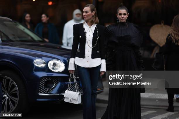 Fashion week guest seen wearing a black and white blouse, jeans and a white Chanel Bag, Chanel earrings and a Chanel necklace and Polina Erofeeva...