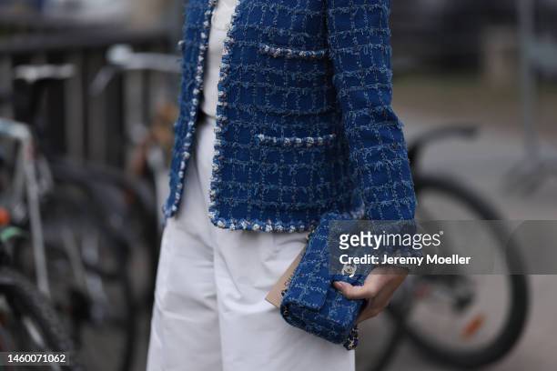 Fashion Week guest seen wearing a blue Chanel blazer, white shirt and pants and matchy blue Chanel handbag, outside the Chanel Show, during Paris...