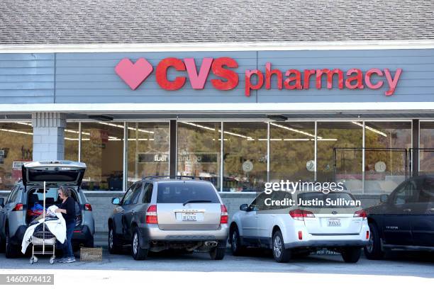 Sign is posted on the exterior of a CVS Pharmacy on January 27, 2023 in Half Moon Bay, California. CVS has announced plans to shorten pharmacy hours...