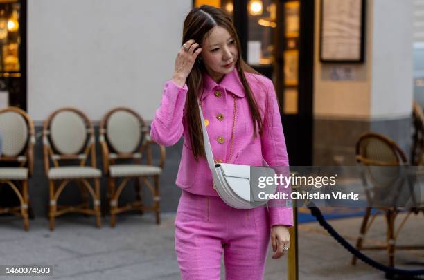 Onnuk wears pink button up jacket, pants, white pants outside Patou at La Samaritaine on January 27, 2023 in Paris, France.