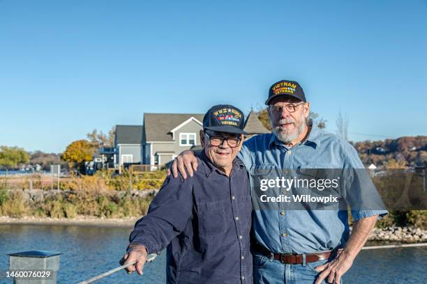 two senior men military war veterans standing side by side - vietnam war photos stock pictures, royalty-free photos & images