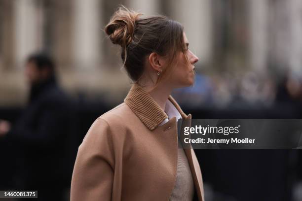 Zita d'Hauteville seen wearing a beige Fendi Peekaboo bag, a beige skirt, beige boots, a brown sweater and a matching brown coat before the Fendi...