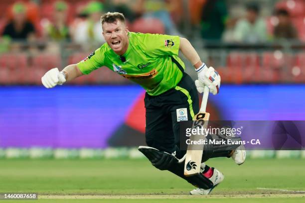 David Warner of the Thunder runs between the wickets during the Men's Big Bash League match between the Sydney Thunder and the Brisbane Heat at...