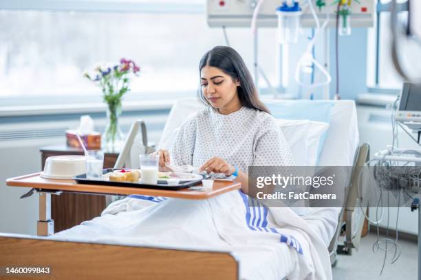 woman eating in the hospital - hospital food stock pictures, royalty-free photos & images