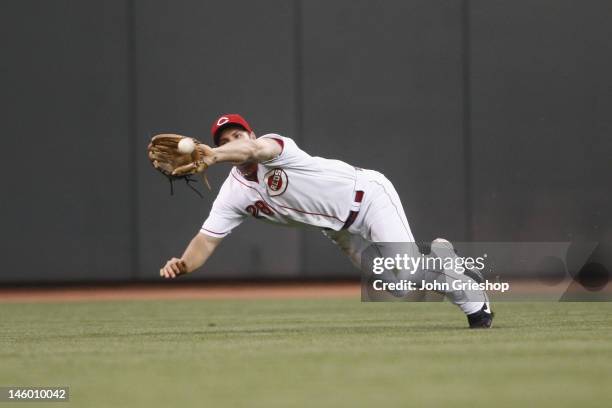 Chris Heisey of the Cincinnati Reds makes the diving catch in centerfield robbing Prince Fielder of the Detroit Tigers of extra bases during their...