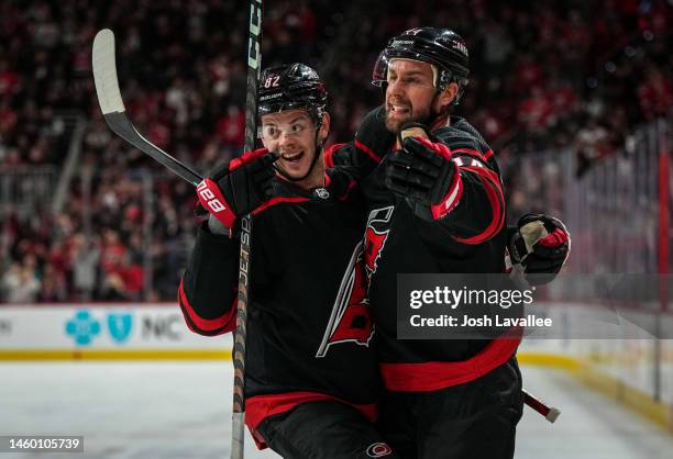 Calvin de Haan of the Carolina Hurricanes celebrates with teammates after a goal during the first period against the San Jose Sharks at PNC Arena on...