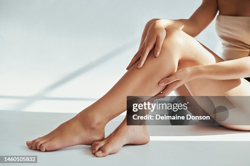 Woman, legs and beauty in studio for skin, grooming and hygiene treatment against grey a background. Girl leg and model relax after skincare, cosmetics and luxury, pamper and self care while isolated Woman, legs and beauty in studio for skin, grooming and hygiene treatment against grey a background. Girl leg and model relax after skincare, cosmetics and luxury, pamper and self care while isolated