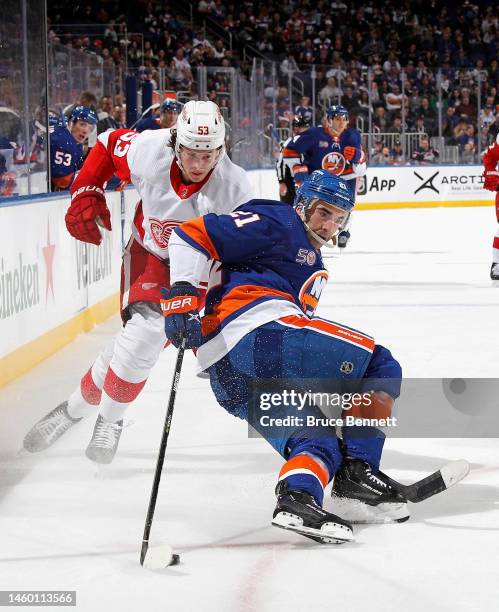 Moritz Seider of the Detroit Red Wings trips up Kyle Palmieri of the New York Islanders during the second period at the UBS Arena on January 27, 2023...