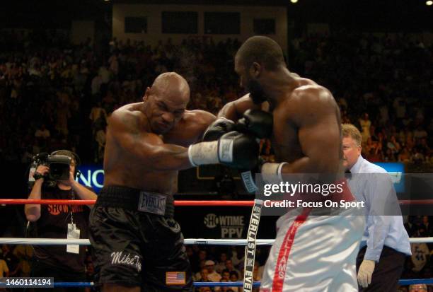 Danny Williams, white trunks, and Mike Tyson, black trunks fights each other during a heavyweight match on July 30, 2004 at Freedom Hall in...