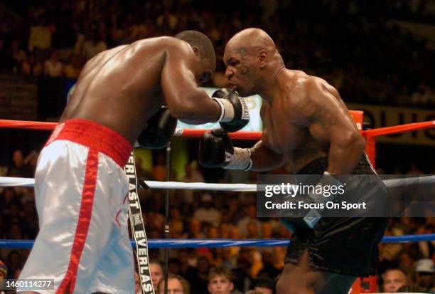 Danny Williams, white trunks, and Mike Tyson, black trunks fights each other during a heavyweight match on July 30, 2004 at Freedom Hall in...