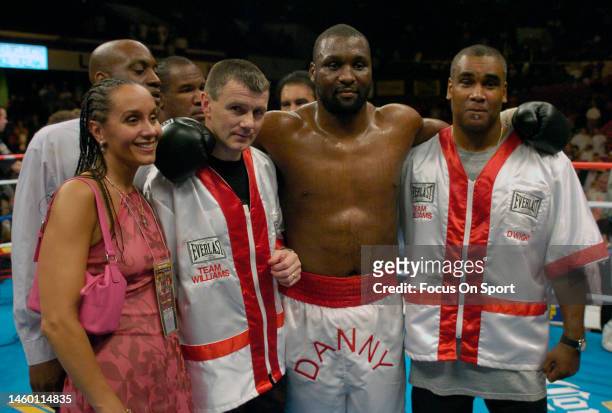 Danny Williams celebrates with his trainers after he knocked out Mike Tyson in the fourth round during a heavyweight match on July 30, 2004 at...
