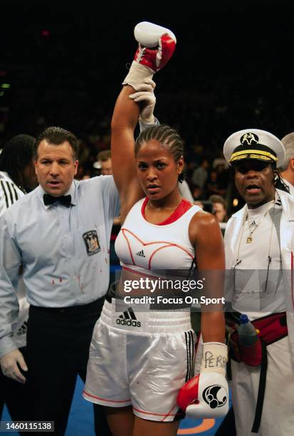 Super middleweight boxer Laila Ali celebrates after she defeated Shelley Burton to retain the WBC female and WIBA super middleweight titles during a...