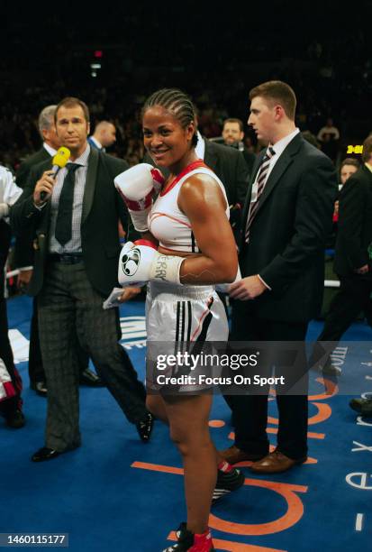 Super middleweight boxer Laila Ali celebrates after she defeated Shelley Burton to retain the WBC female and WIBA super middleweight titles during a...