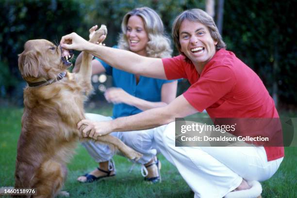 American actor John Ritter poses for a portrait with his dog and wife Nancy Morgan in Los Angeles, California, circa 1985.