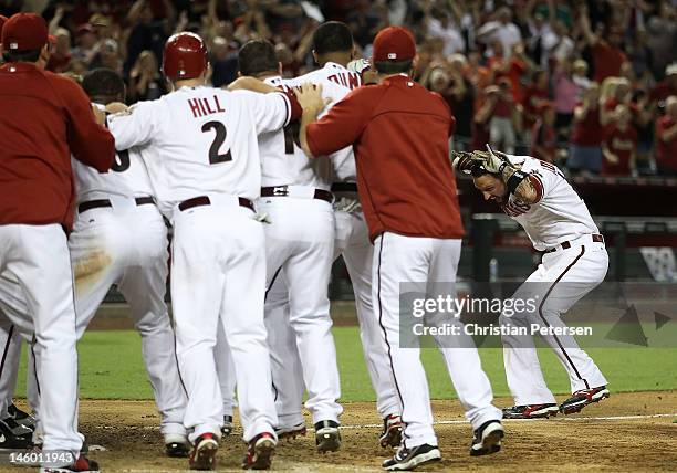 The Arizona Diamondbacks congratulate Ryan Roberts after he hit a walk off three-run home run against the Oakland Athletics during the ninth inning...