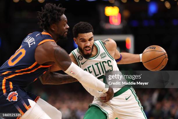 Jayson Tatum of the Boston Celtics drives towards the basket against Julius Randle of the New York Knicks during the second half at TD Garden on...