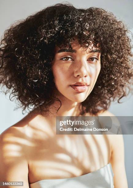 portrait, face and aesthetic with a model black woman in studio for wellness, treatment or natural skincare. facial, beauty and luxury with an attractive young female posing to promote cosmetics - natural condition stockfoto's en -beelden