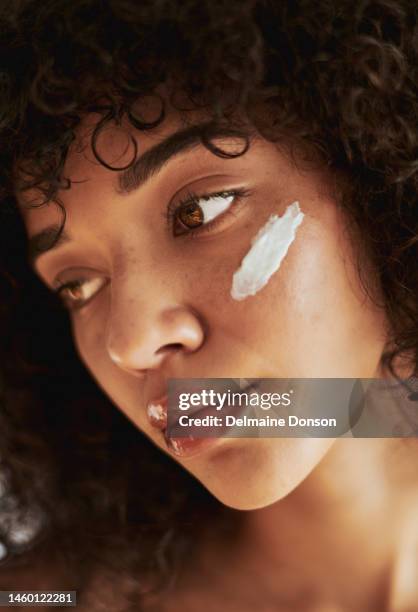black woman, beauty cream and skincare or sunscreen with dermatology, cosmetics product. wellness model in studio for skin glow, natural hair and self care with healthy facial cosmetic on face - beauty treatment stock pictures, royalty-free photos & images