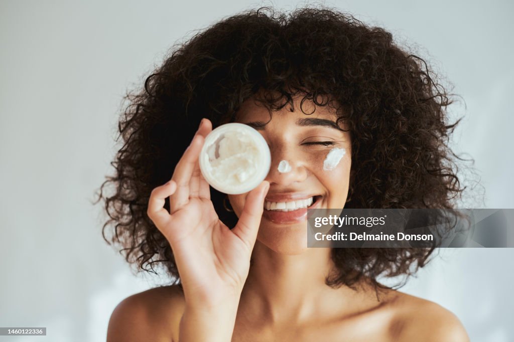 Cream, lotion and face of black woman with beauty product, skincare cosmetics and advertising isolated on white wall. Beautiful skin care person with container, moisturizer and skin care mockup
