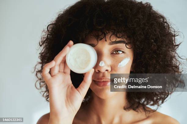 cream, lotion and face of black woman skincare product, beauty cosmetics and advertising isolated on a white wall. beautiful skin care female in portrait for facial promotion or essential oil mockup - woman face cleaning stock pictures, royalty-free photos & images