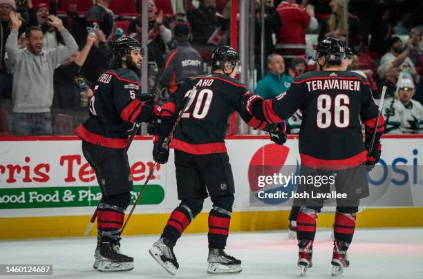 Sebastian Aho of the Carolina Hurricanes celebrates with teammates after scoring a goal during the third period against the San Jose Sharks at PNC...