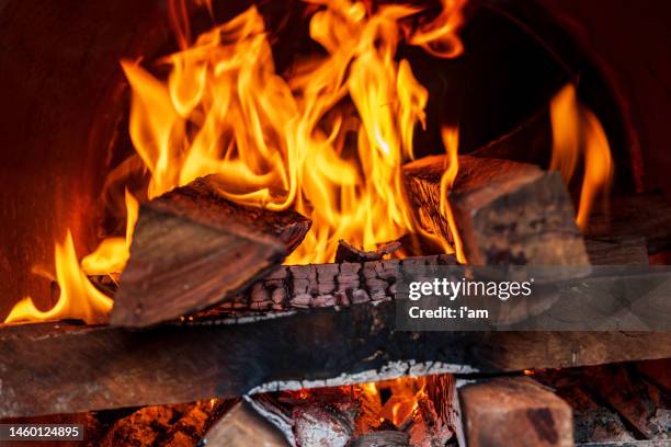 close up shot of burning firewood in the fireplace. - campfire background stock pictures, royalty-free photos & images