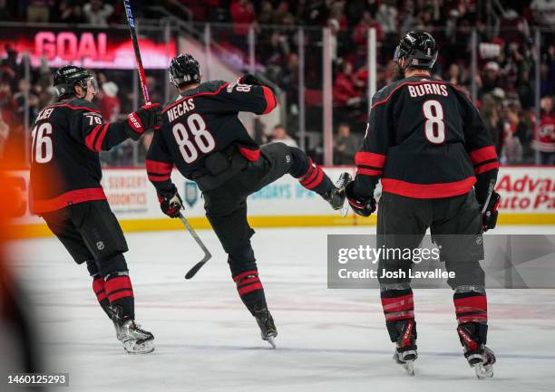 Martin Necas of the Carolina Hurricanes celebrates with teammates after scoring a goal during the third period against the San Jose Sharks at PNC...