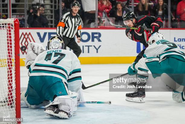Martin Necas of the Carolina Hurricanes scores the game-winning goal in overtime against the San Jose Sharks at PNC Arena on January 27, 2023 in...