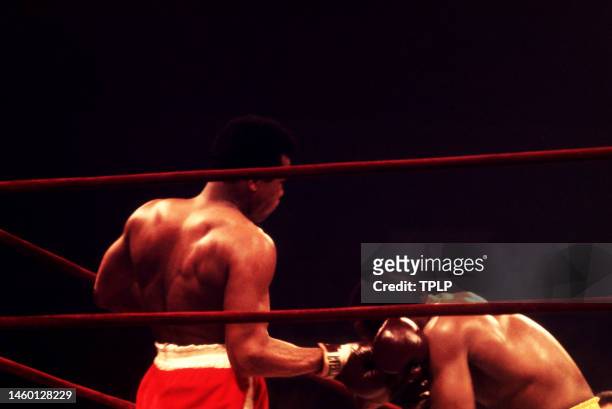 American heavyweight boxing champion Muhammad Ali throws a punch on current champion Joe Frazier during their 'Fight of the Century' bout at Madison...