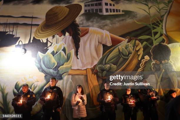 San Mateo County sheriff deputies hold candles during a candlelight vigil for the victims of the recent mass shooting in Half Moon Bay on January 27,...