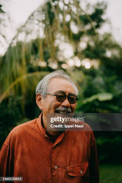 happy senior japanese man in nature - okinawa prefecture stock-fotos und bilder