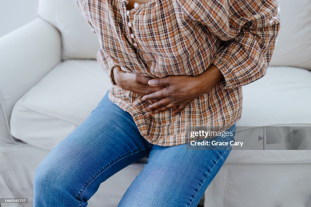 Woman Holds Her Abdomen in Pain